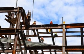 Construction workers on steel beams in construction site of skyscraper in New York